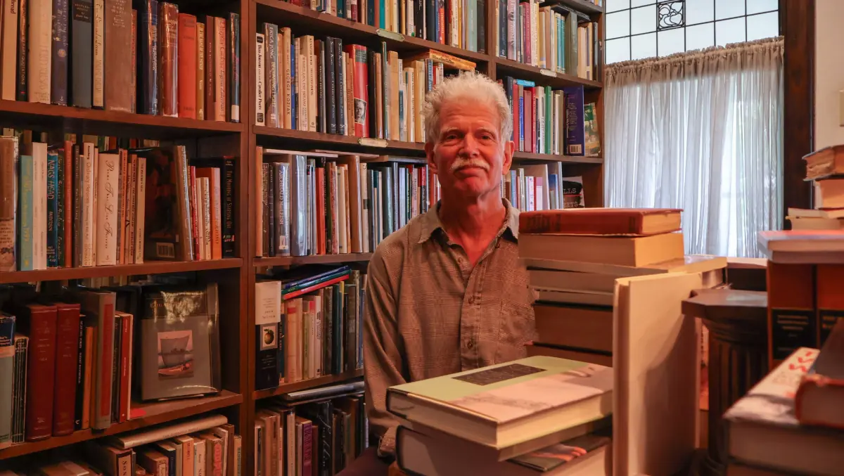Philip Schatz poses for a photograph at Erasmus Books.